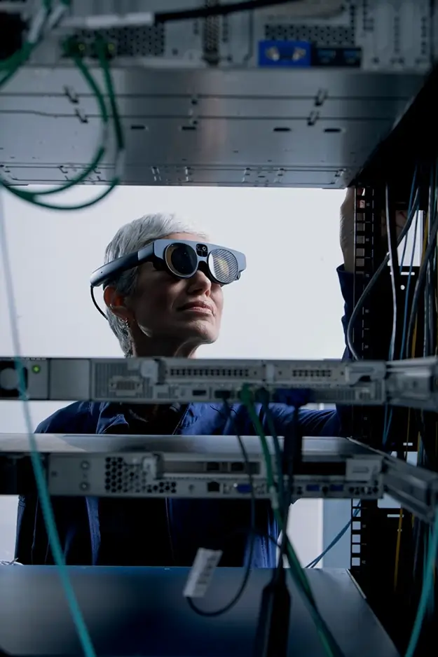 Woman wearing AR device in server room