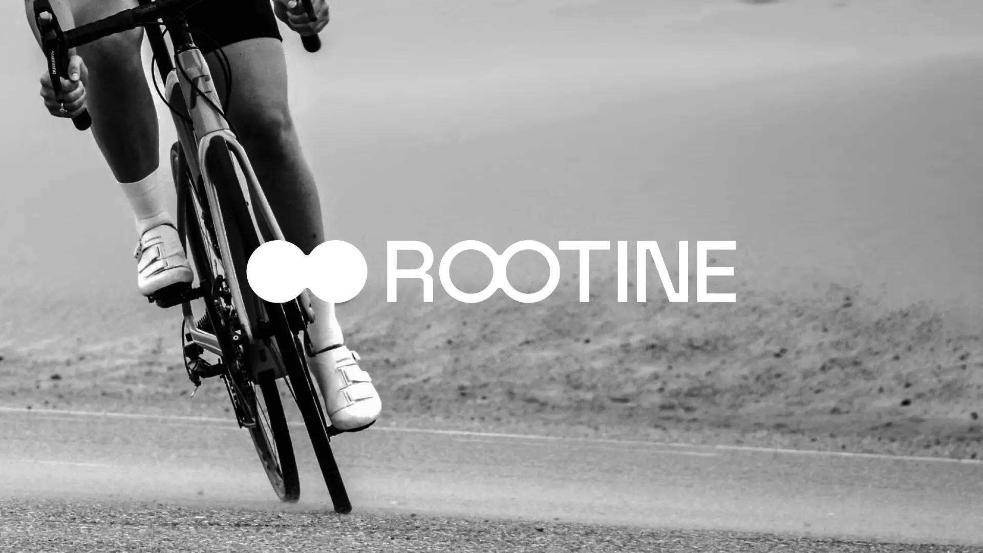 Black and white image of cyclist with Rootine logo